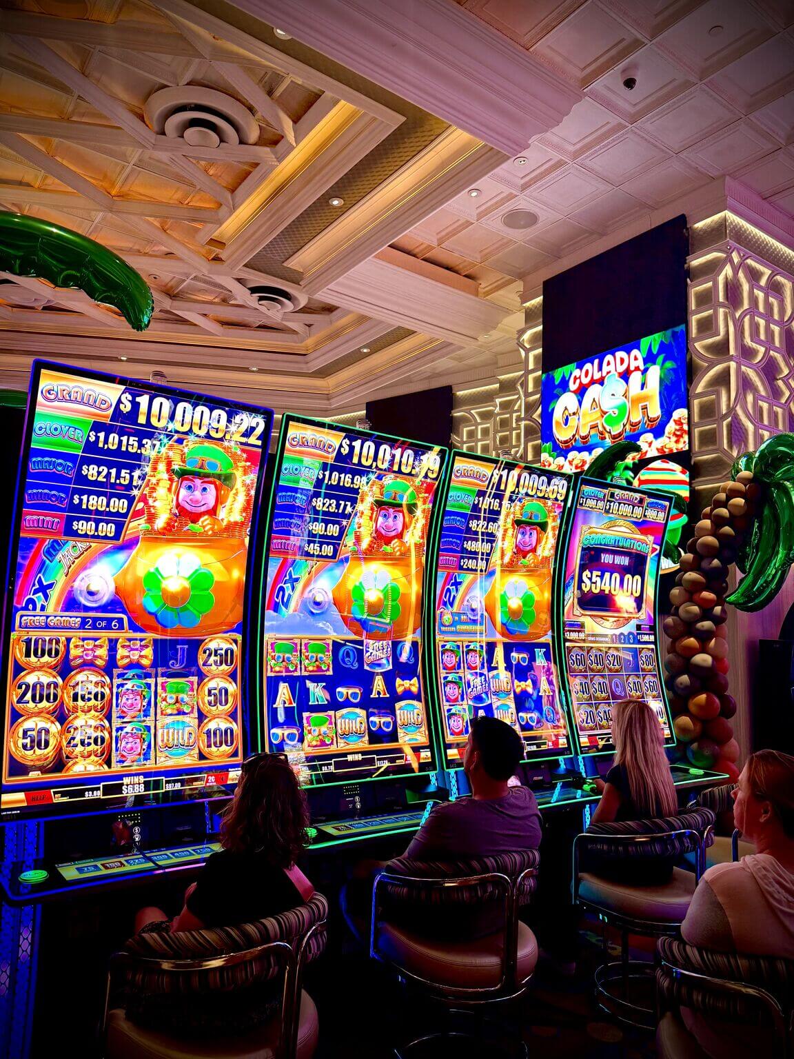 Casino floor with illuminated gaming displays and player-facing touchscreens